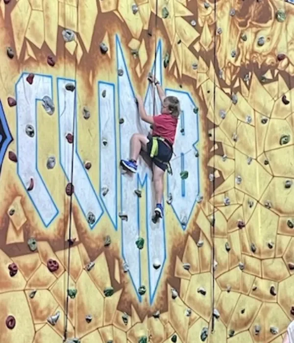 Teenage kid rockclimbing