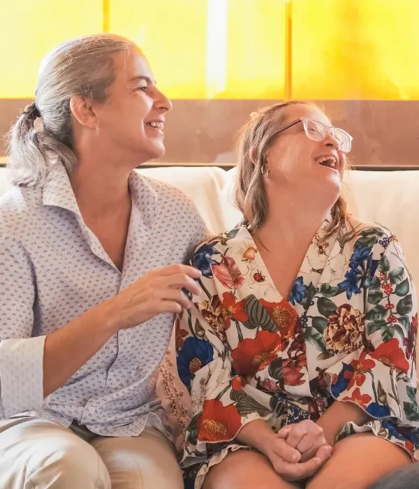 Disabled woman laughing with support worker