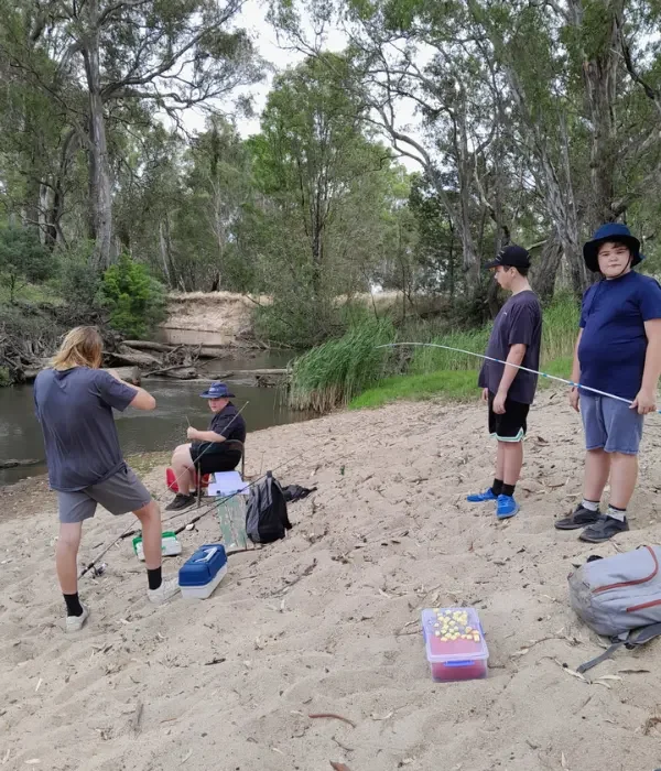 Group of friends fishing on the sand