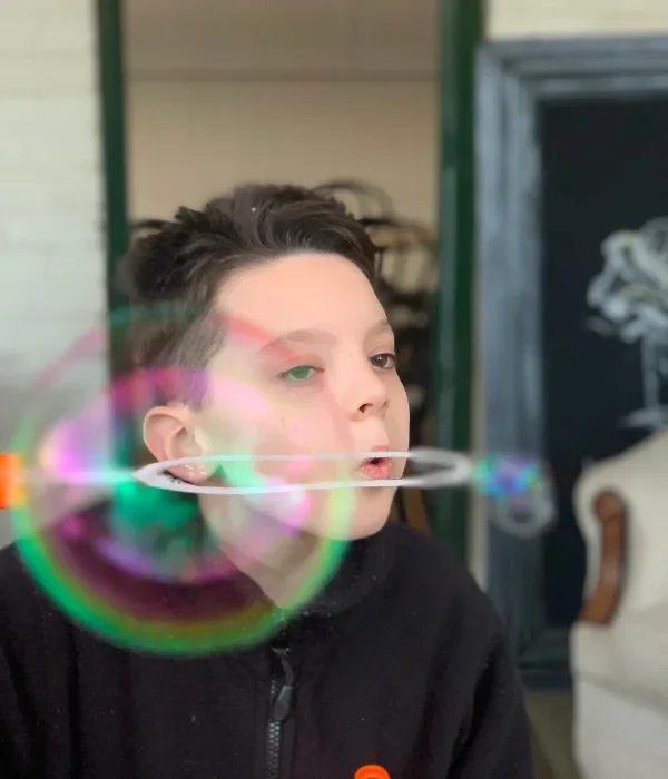 Young child blowing a bubble