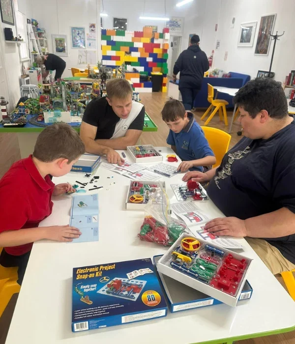 Group of NDIS participants playing a game together at table